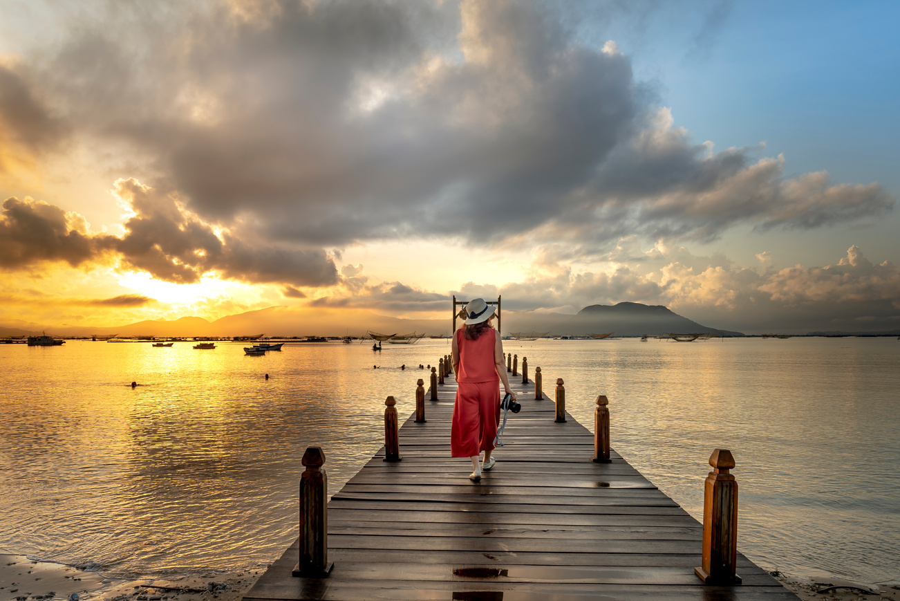 Woman Walking On Beach Dock